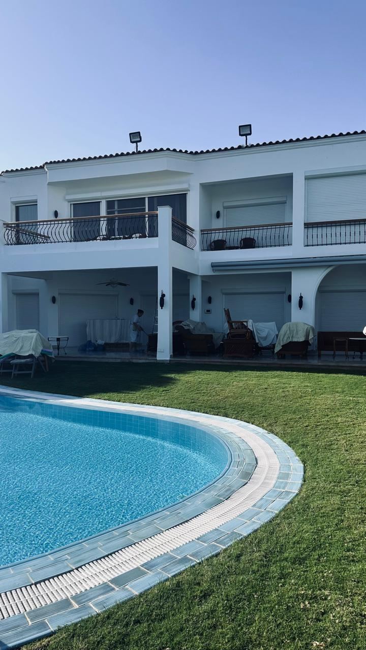 Villa terrace and pool area with roller shutters